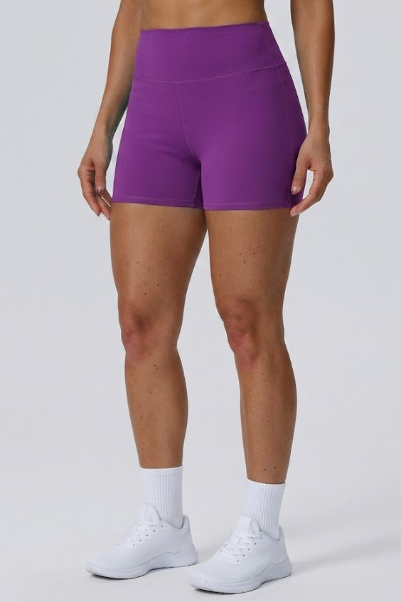 Person wearing purple athletic shorts on a plain background