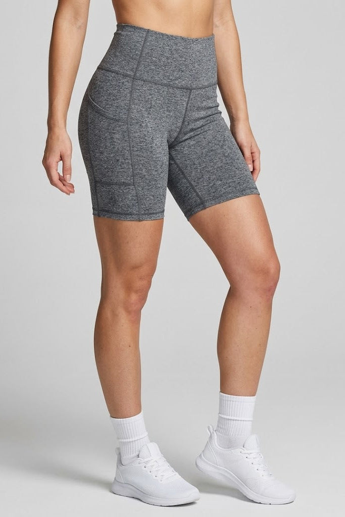 Person wearing gray athletic shorts on a plain background