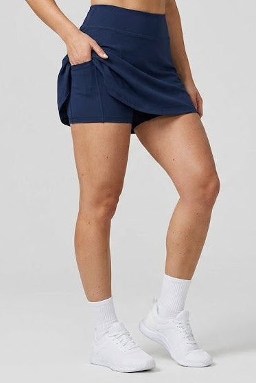 Person wearing navy athletic shorts on a white background