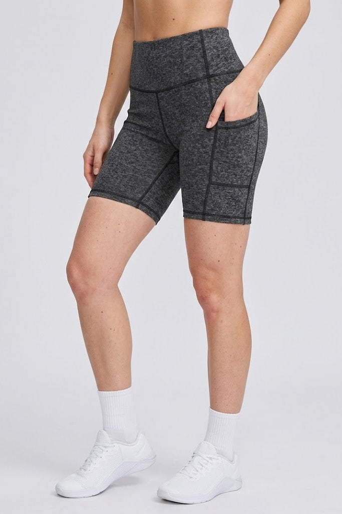 Person wearing gray athletic shorts on a white background
