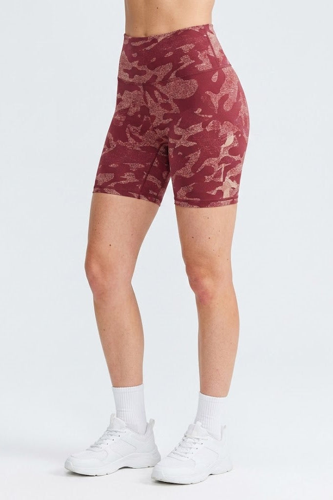 Maroon patterned shorts worn by a person on a white background