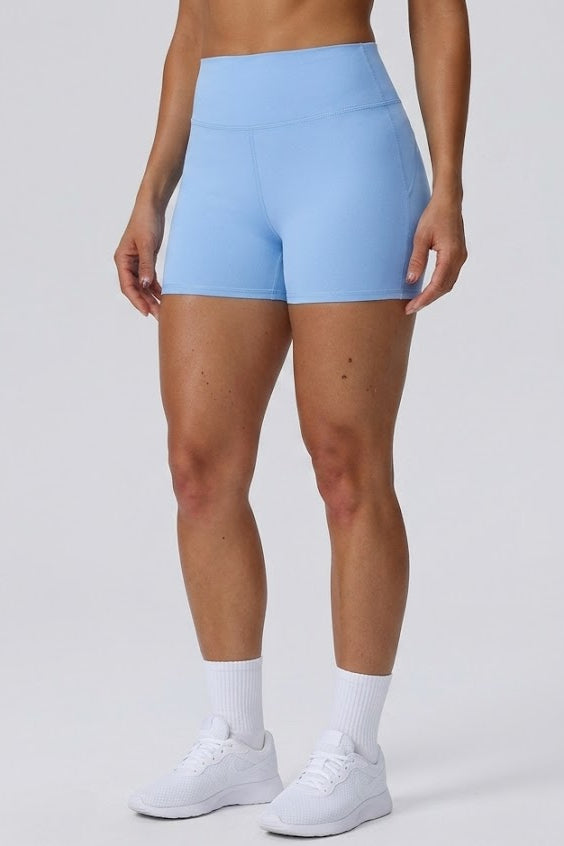 Person wearing light blue athletic shorts on a plain background