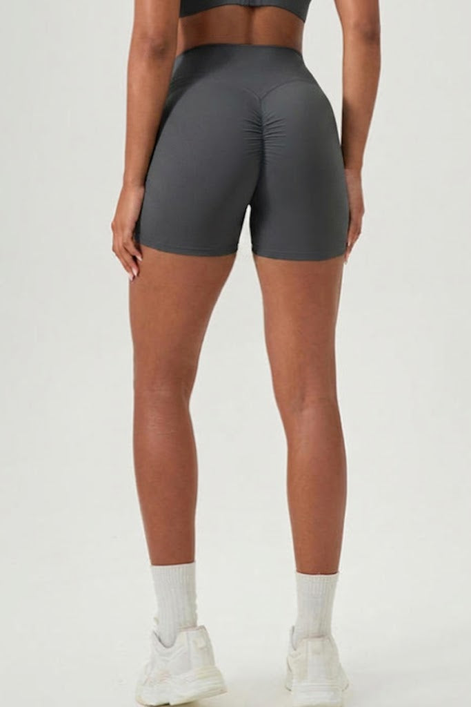 Person wearing gray athletic shorts on a white background