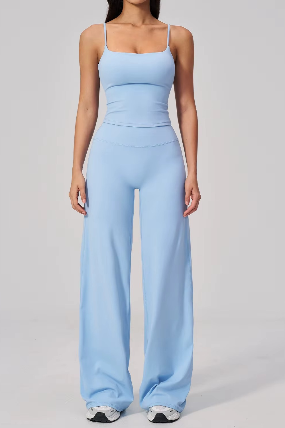 Light blue jumpsuit worn by a person on a gray background