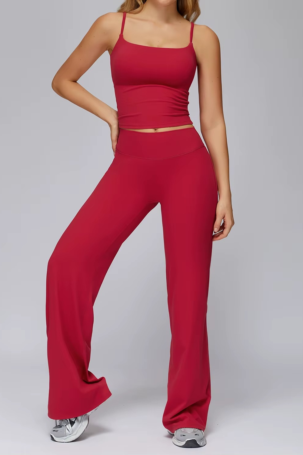 Person wearing a red athletic outfit on a gray background