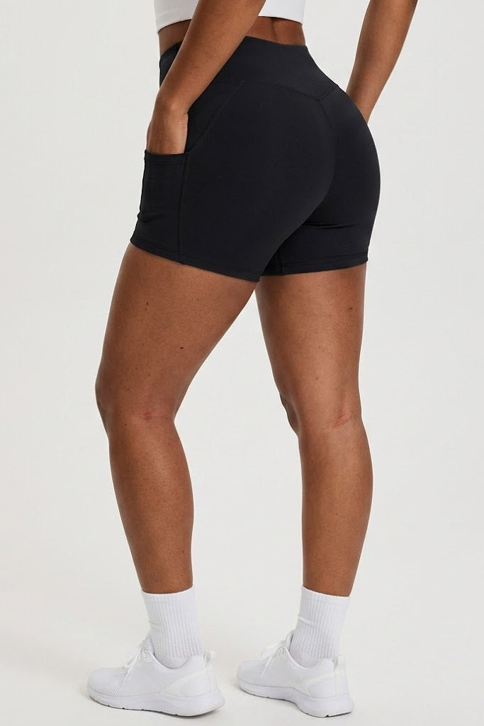 Person wearing black athletic shorts on a white background