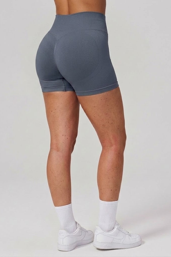 Person wearing gray athletic shorts on a plain background