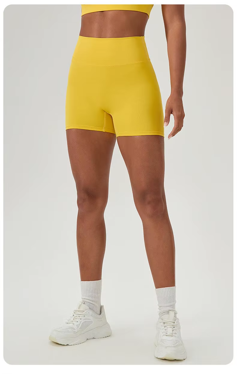 Person wearing yellow shorts on a plain background