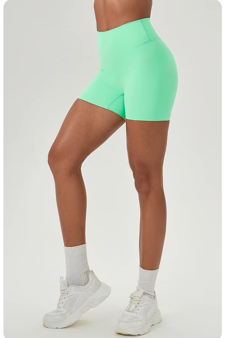 Person wearing bright green shorts on a white background